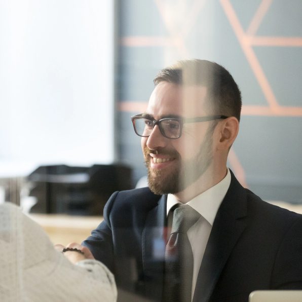 Man listening and smiling in office